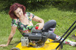 Smilling happy women oiling lawn mover