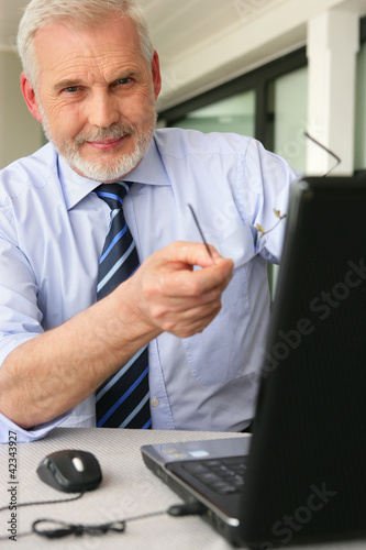Photo: Man pointing to his laptop Man pointing to his laptop