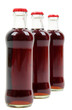 Photo: three glass bottles with cola three glass bottles with cola
