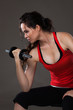 Beautiful young  woman lifting weights