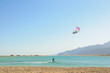kitesurfer in lagoon surrounded by desert mountains