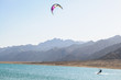 kitesurfer in lagoon surrounded by desert mountains