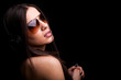Photo: Beautiful young woman listening to music with headphones on blac Beautiful young woman listening to music with headphones on blac