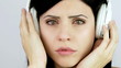 Closeup of sad girl crying while listening to music