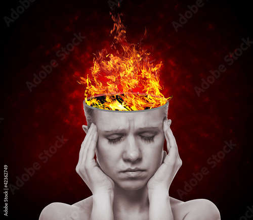 Photo: concept, an idea. head of woman with a flame of fire concept, an idea. head of woman with a flame of fire