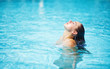 Photo: Young woman in the swimming pool Young woman in the swimming pool
