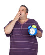 Foto: Fat man with a blue alarm clock yawning Fat man with a blue alarm clock yawning