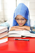 A young muslim woman reading a book