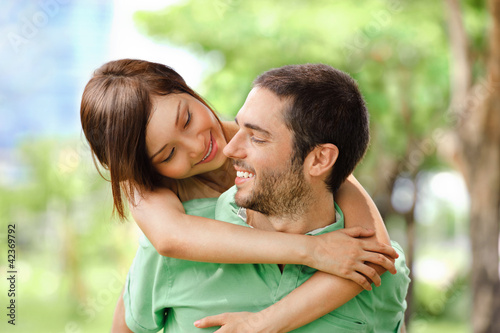 Photo: Happy girl embracing handsome male outside Happy girl embracing handsome male outside