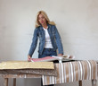 Beautiful young woman chooses wallpaper