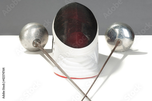Photo: fencers sword and mask on a white background fencers sword and mask on a white background
