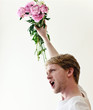 Young man fighting for his love with flowers