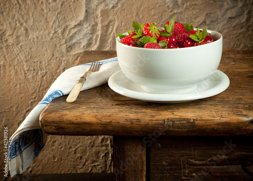 Photo: Red fruit on an old table Red fruit on an old table