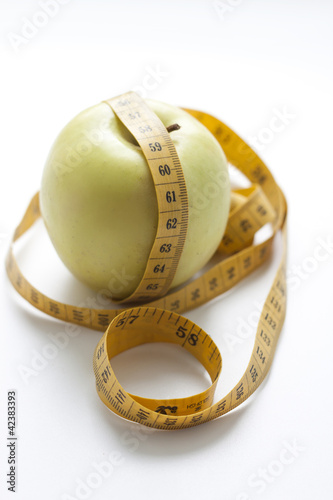 Photo: apple and measuring tape apple and measuring tape