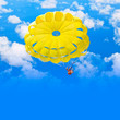 Photo: Female parachutist over blue summer sky Female parachutist over blue summer sky