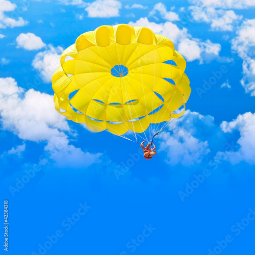 Photo: Female parachutist over blue summer sky Female parachutist over blue summer sky