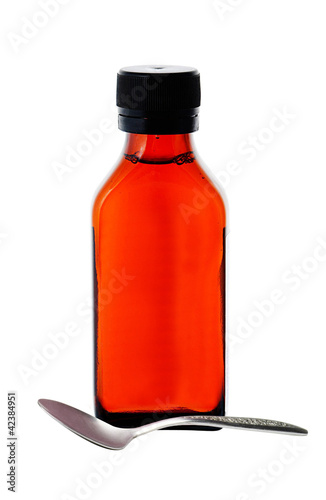 Photo: Close up of medicine bottle with red syrup and spoon isolated on Close up of medicine bottle with red syrup and spoon isolated on
