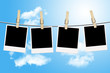 Photo: Blank photographs hanging on a clothesline with blue sky Blank photographs hanging on a clothesline with blue sky