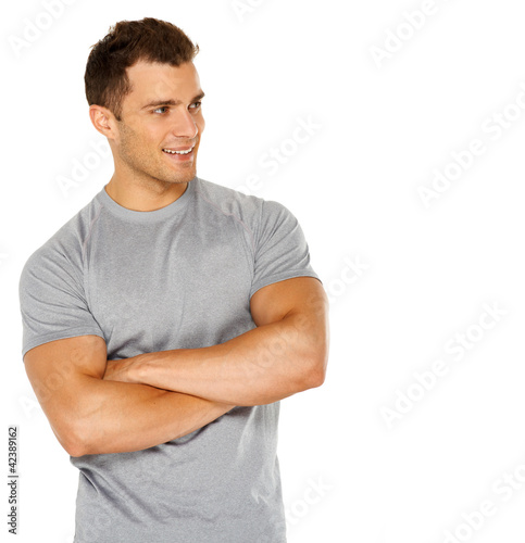 Photo: Handsome man with arms crossed looking his left on white Handsome man with arms crossed looking his left on white