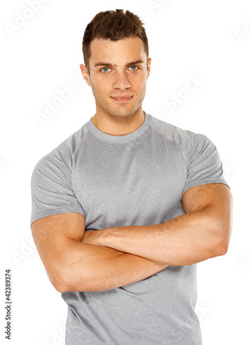 Photo: Happy fit male posing over white background Happy fit male posing over white background