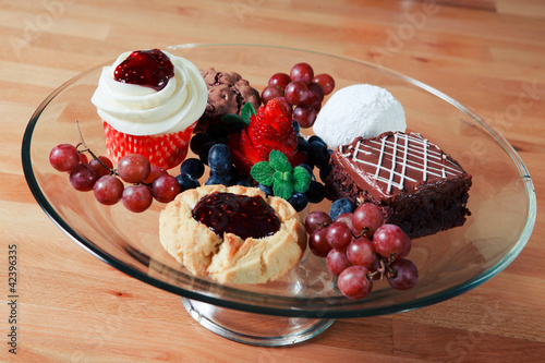 Photo: Glass tray of a variety of differenet desserts Glass tray of a variety of differenet desserts