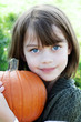 Photo: Child Holding a Pumpkin Child Holding a Pumpkin