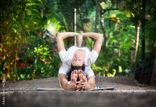 Photo: Couple yoga in garden Couple yoga in garden