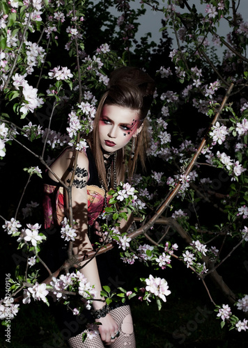 Photo: Beautiful woman among spring blossom. Flowers of apple tree Beautiful woman among spring blossom. Flowers of apple tree