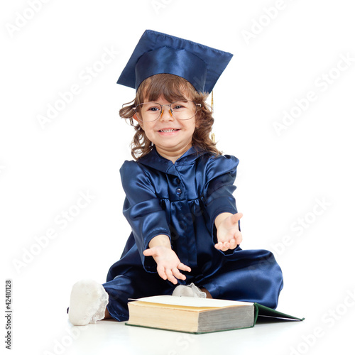 Photo: Emotional funny child in academician clothes with book Emotional funny child in academician clothes with book
