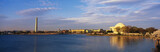 Photo: This is the Jefferson Memorial and Washington Monument in the spring. Cherry blossoms are blooming on the trees. There is a blue sky with white clouds and the setting is all next to the Tidal Basin. This is the Jefferson Memorial and Washington Monument in the spring. Cherry blossoms are blooming on the trees. There is a blue sky with white clouds and the setting is all next to the Tidal Basin.