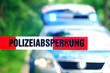 Polizeiabsperrung mit Polizeifahrzeug