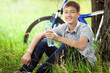 The cyclist in the park drinking clean water