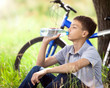 The cyclist in the park drinking clean water