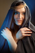 young woman with hoody and folded hands thinking.