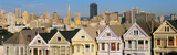 Photo: These are the historic Victorian homes in front of the skyline on Steiner Street. They are painted pastel colors and line up next to each other in row house formation. These are the historic Victorian homes in front of the skyline on Steiner Street. They are painted pastel colors and line up next to each other in row house formation.