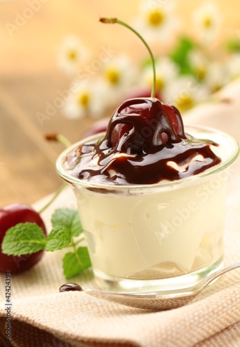 Foto: dairy dessert with chocolate sauce and cherries dairy dessert with chocolate sauce and cherries