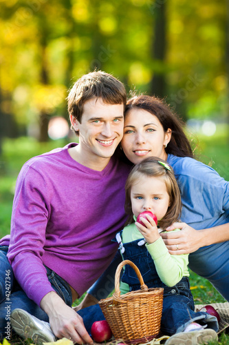 Photo: Family having picnic in autumn Family having picnic in autumn