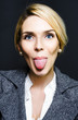 Cheeky business woman sticking out tongue