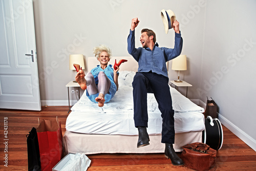 Photo: couple in a hotel room with new red shoes couple in a hotel room with new red shoes