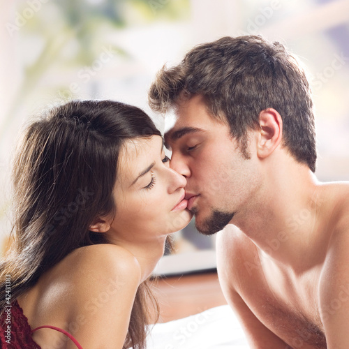 Photo: Couple making love in bed Couple making love in bed