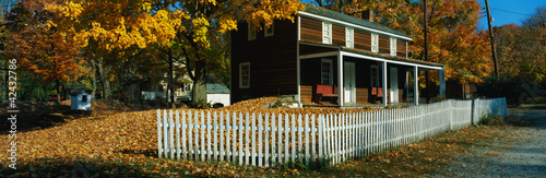 Photo: This is a brown, wooden house in a historic village near the Delaware River. A white picket fence surrounds the house. There are autumn leaves on the trees surrounding the property. This is a brown, wooden house in a historic village near the Delaware River. A white picket fence surrounds the house. There are autumn leaves on the trees surrounding the property.