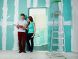 Foto: Young couple checking the plans of their building lot Young couple checking the plans of their building lot