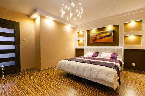 Photo: Modern master bedroom interior with picture of shipwreck Modern master bedroom interior with picture of shipwreck