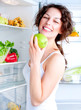 Beautiful Young Woman near the Refrigerator with healthy food