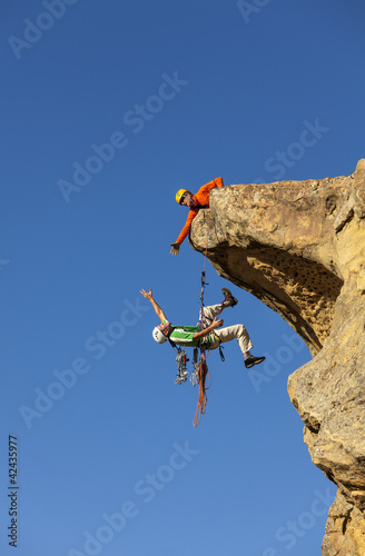 Photo: Climbing team struggles to the summit. Climbing team struggles to the summit.