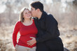 Cute happy young pregnant married couple outdoors