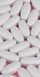 white pill on pink background
