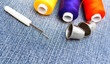 Threads and thimbles on jeans.