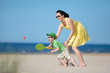 Young mother and son playing on the beach