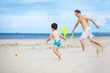 Father and son playing on the beach